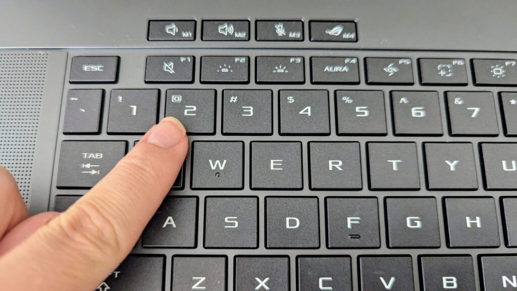 Me pointing at the @ symbol above the number 2, which is where I'm used to it being.