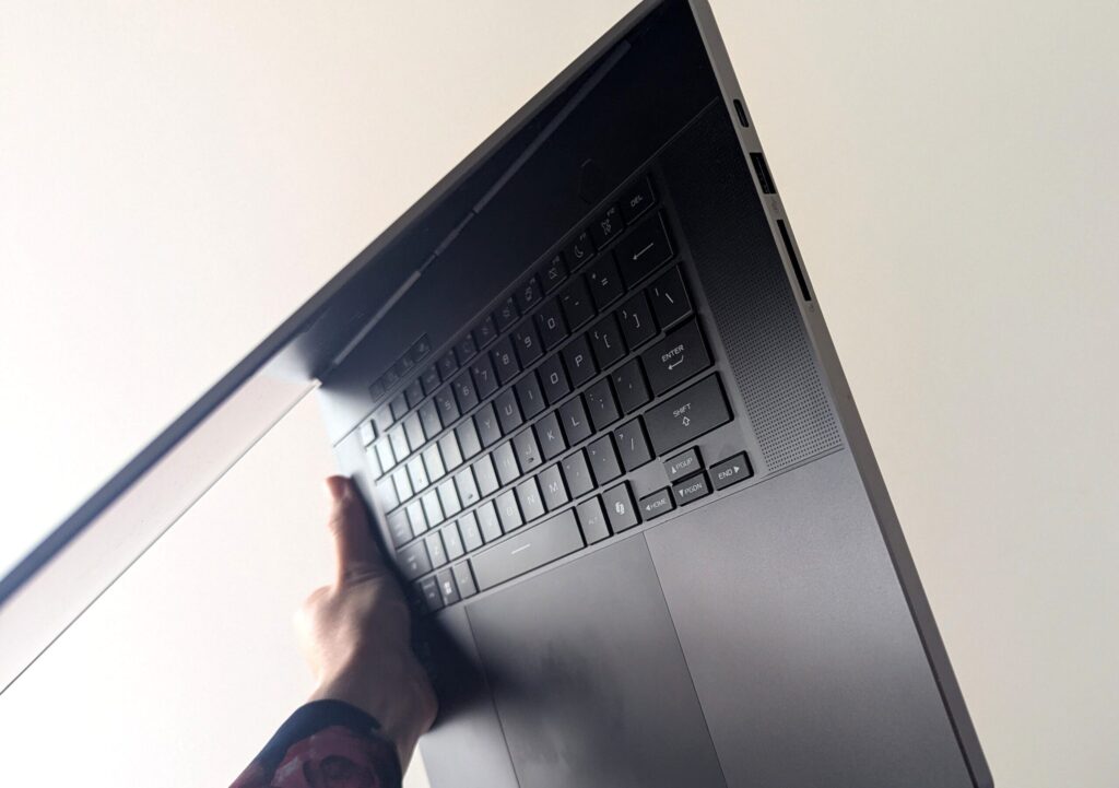 My hand happily holding up my lovely new laptop computer