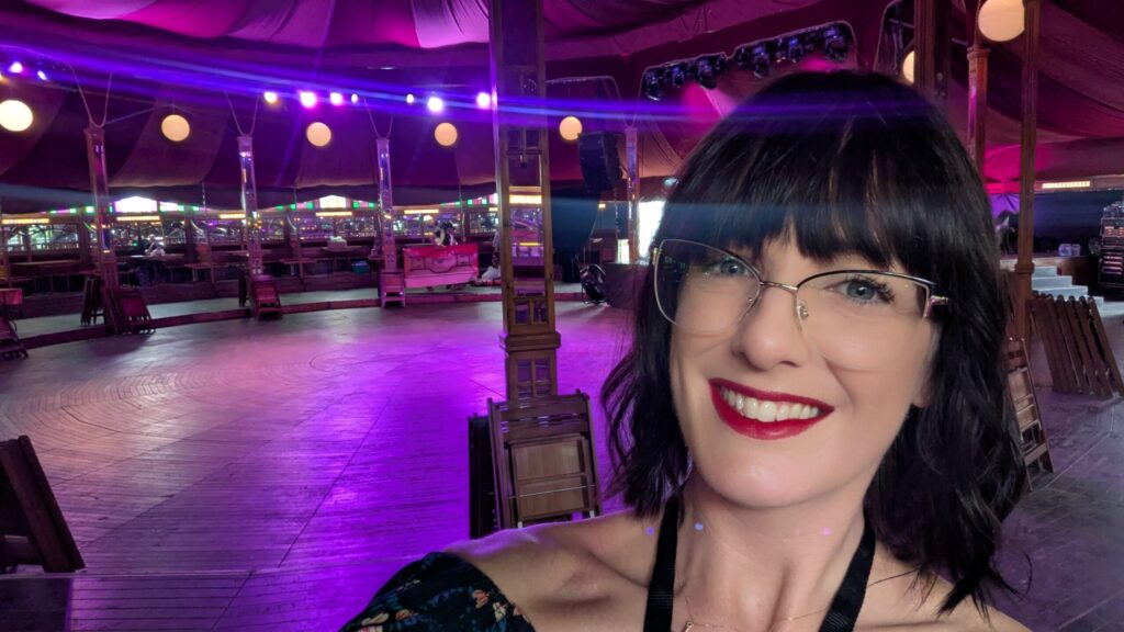 Photo of me smiling, inside The Spiegeltent at the Cabaret of Ideas.