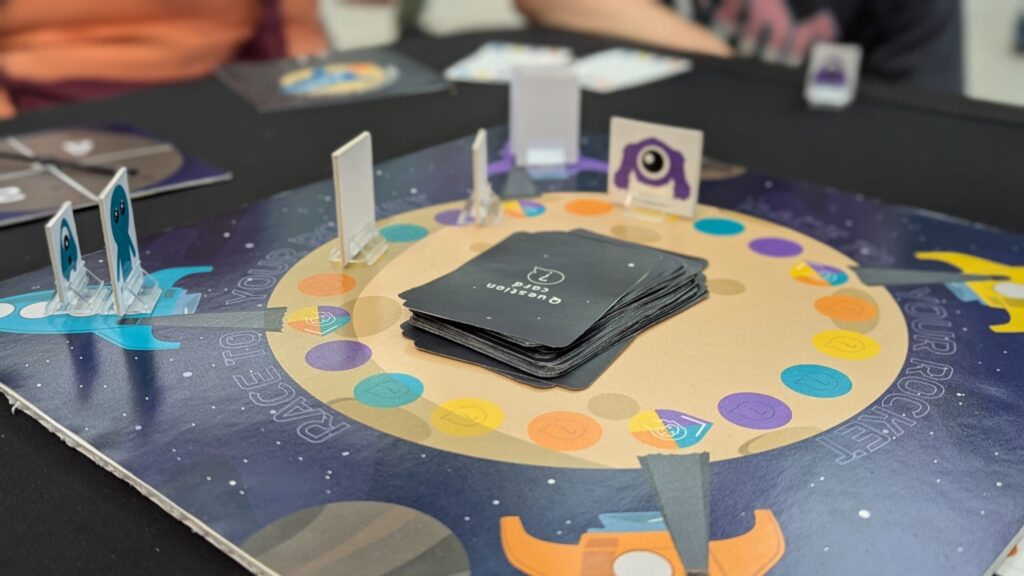 Close up of the Race To Your Rocket Board Game being played by young children at Norwhich Games Festival 2025